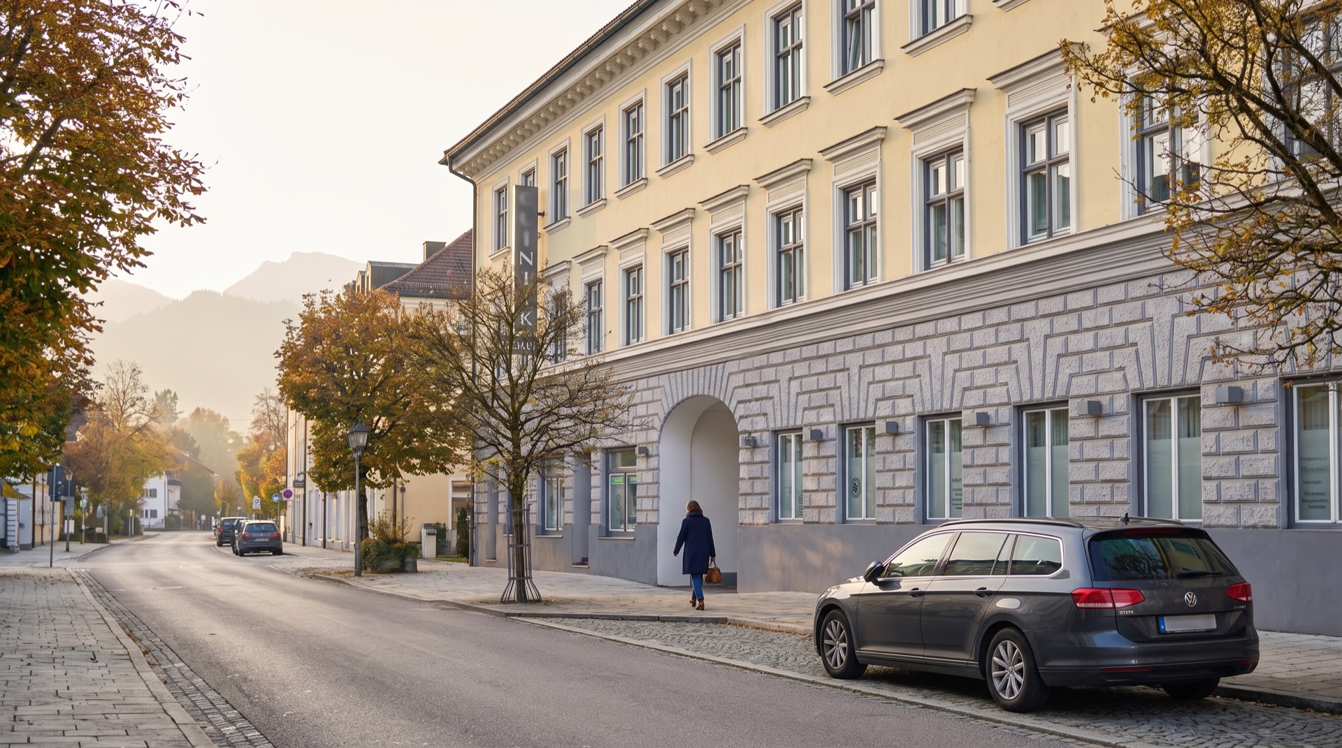 The clinic façade on Rosenheimer Straße in Bad Aibling, the Alpine foothills hazy behind it.